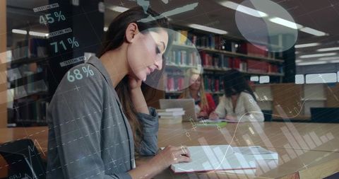 Focused student taking notes in library with digital analytics overlay showing progress