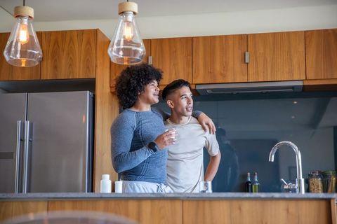 Couple Drinking Water in Modern Kitchen