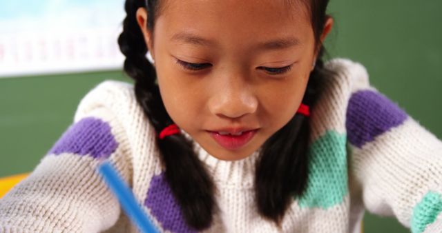 Young Schoolgirl Concentrating on Homework in Classroom - Download Free Stock Images Pikwizard.com