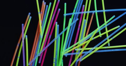 Colorful glow sticks on black background for party and events