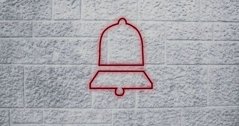 Minimalist red bell outline on stone wall