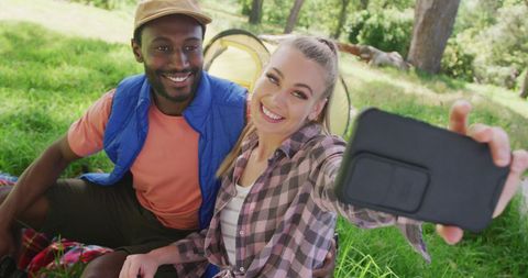 Diverse Couple Smiling Taking Selfie Outdoors