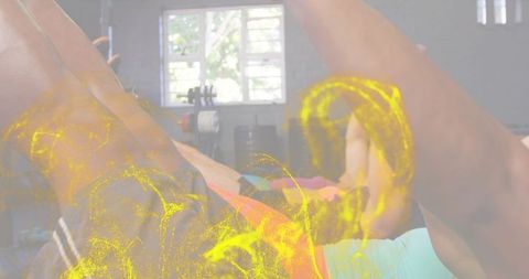 Group performing core workout in gym with dynamic yellow energy overlay