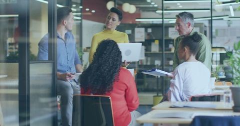 Collaborative Meeting and Presentation in Modern Office Setting