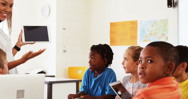 Teacher Showing Tablet to Engaged Students in Classroom - Download Free Stock Images Pikwizard.com