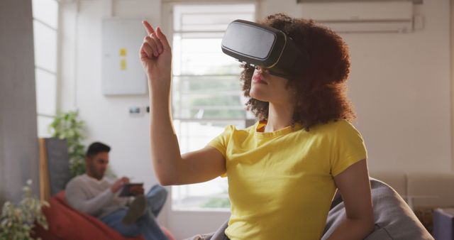 Woman Using Virtual Reality Headset at Home for Interactive Experience - Download Free Stock Images Pikwizard.com