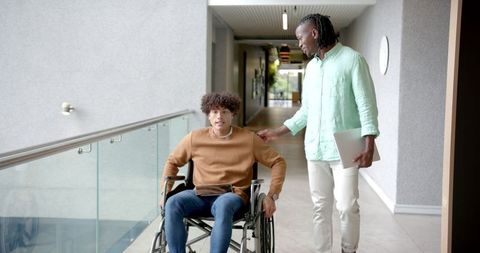 Colleagues Collaborating in Office Corridor, Emphasizing Inclusivity