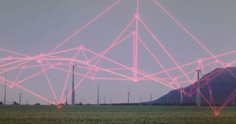 Wind Farm Linked by Neon Pink Network Overlay at Twilight Over Green Field and Mountain
