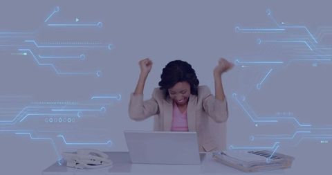 Excited Businesswoman Celebrating Achievement with Modern Tech Interface