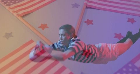 Dynamic performer in striped outfit with american flags