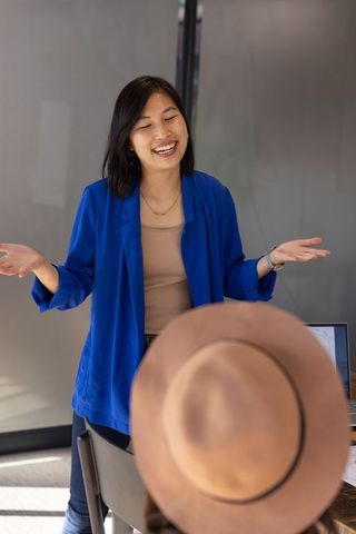 Confident professional woman presenting in office meeting