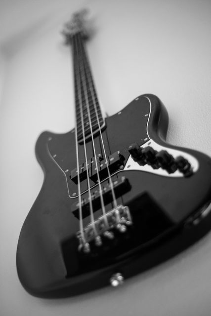 This image is perfect for use in music-related content, promotional materials for rock bands, instrument retailers, or design projects. The high contrast and close-up detail enhance its appeal for artistic and educational purposes, such as blog posts about music equipment, album covers, or tutorials on guitar playing.