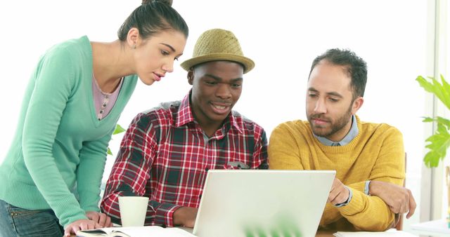 Diverse Team Collaborating Over Laptop in Office - Download Free Stock Images Pikwizard.com