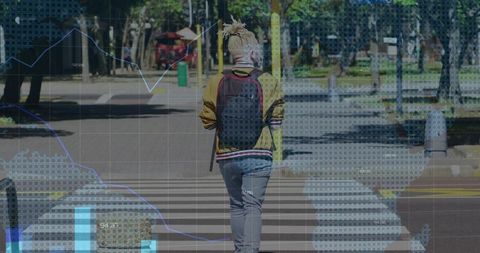 Urban commuter walking across crosswalk in mustard jacket and backpack with data overlay