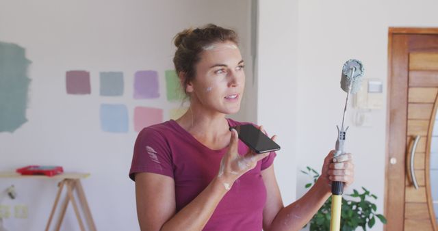 Woman Painting Interior While Talking on Phone - Download Free Stock Images Pikwizard.com