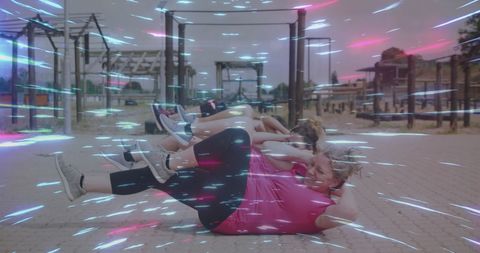 Women Exercising at Obstacle Course with Digital Light Trails