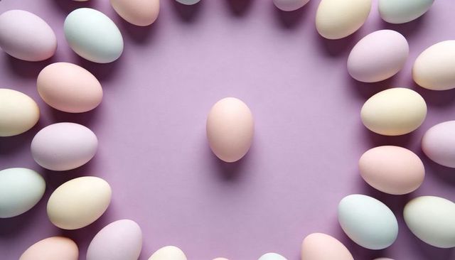 Centered pastel egg surrounded by circular ring of soft-colored eggs on lavender, minimal symmetry