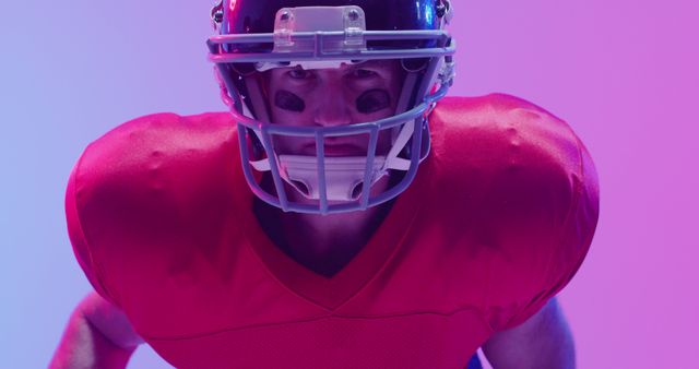 Image of caucasian american football player in helmet over neon purple background. American football, sports and competition concept.