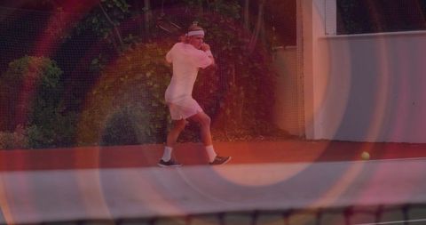 Dynamic Tennis Player Ready to Strike Backhand Shot on Court