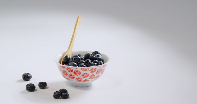 Fresh Blueberries in Decorative Bowl with Wooden Spoon on White Background - Download Free Stock Images Pikwizard.com