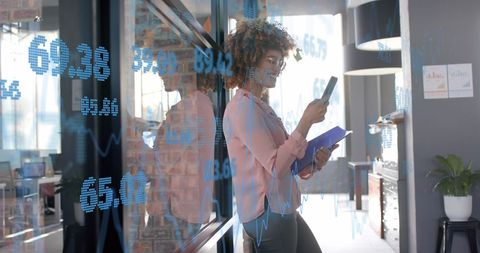 Confident Businesswoman Analyzing Data via Smartphone in Modern Office