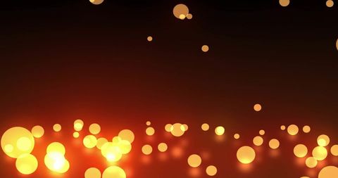Glowing orange and yellow light spots against dark background