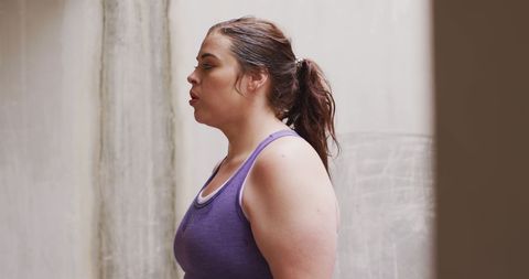 Caucasian Woman in Workout Attire Resting During Training