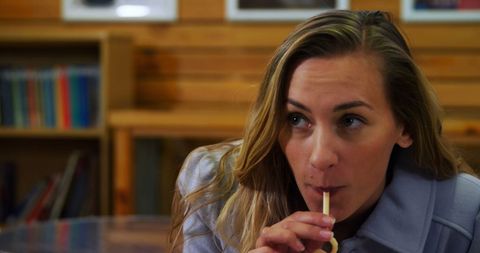 Close-Up of Woman Drinking Smoothie in Cafe