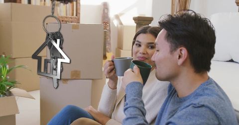 Couple Enjoying Tea with House Key in New Home