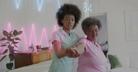 Senior woman exercising with nurse and digital health display