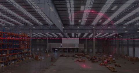 Digital Finance Graphs Overlaying Large Warehouse Interior