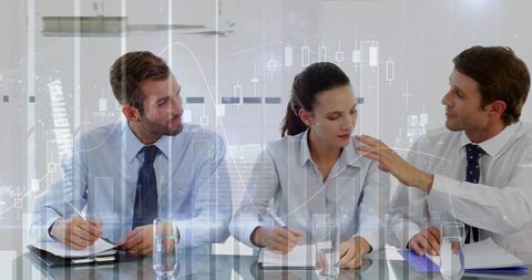 Business Team Analyzing Financial Charts at Conference Table