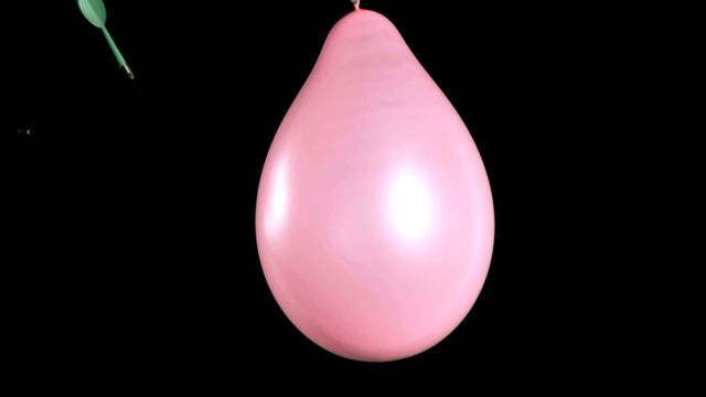 This portrays a dramatic moment of a dart puncturing a pink balloon in super slow motion, creating tension and excitement. Useful for adding a dynamic visual in presentations about physics, pressure, motion, or celebrating events. Ideal for marketing materials, party planning, or educational content demonstrating action and reaction.