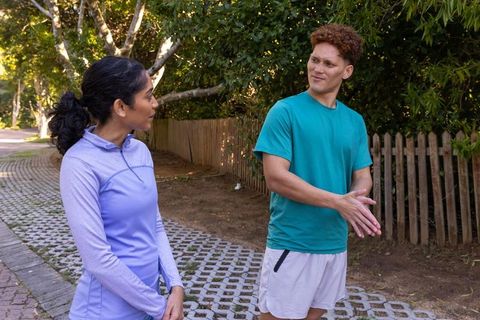 Diverse Friends Chatting Outdoors on Park Pathway
