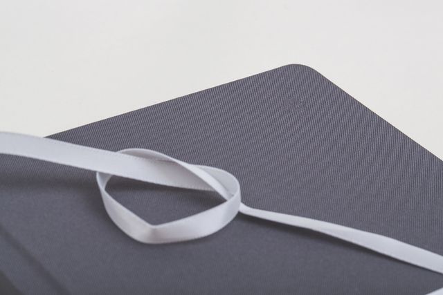 Elegant Gray Book Wrapped in White Ribbon on White Background - Download Free Stock Images Pikwizard.com