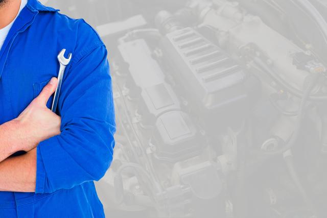 Digital composite of Midsection of mechanic holding wrench