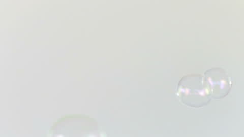 Slow Motion Soap Bubbles Floating in Minimalist Light Setting
