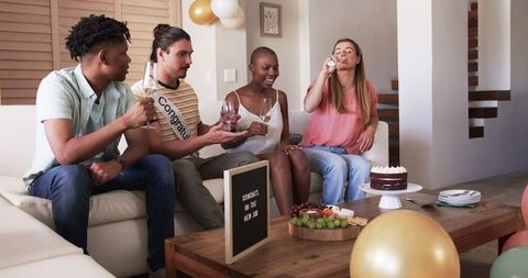 Diverse Group Friends Celebrating with Drinks and Cake at Home