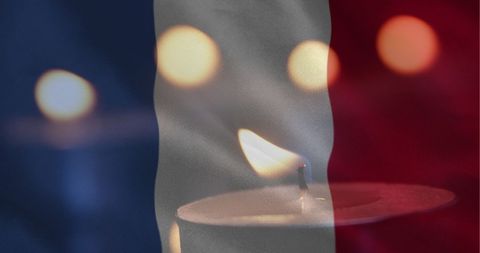 French Flag Illuminated with Soft Candlelight Tribute