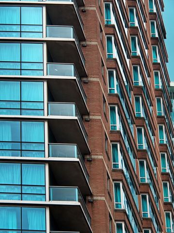 Modern architectural condo facade with brick and glass elements