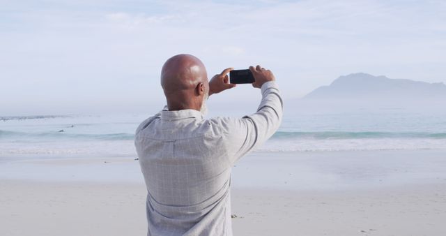 Man Taking Photo of Ocean Scene with Smartphone on Beach - Download Free Stock Images Pikwizard.com