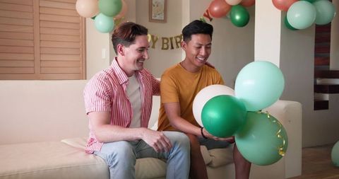 Happy Gay Couple Enjoying Birthday Celebration at Home
