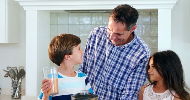 Smiling Father Enjoying Breakfast Time with Son and Daughter in Kitchen - Download Free Stock Images Pikwizard.com