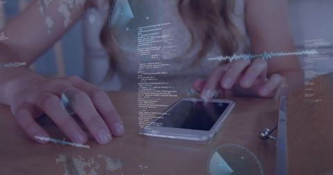 Female hands tapping smartphone on wooden desk with futuristic hud overlays and code