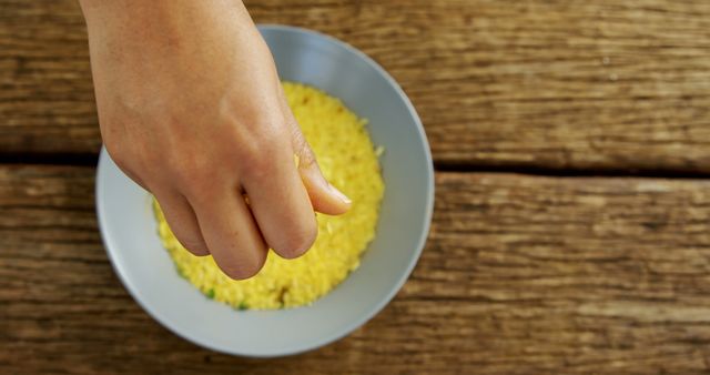 Hand Pressing Fresh Lemon Over Bowl of Crushed Corn - Download Free Stock Images Pikwizard.com