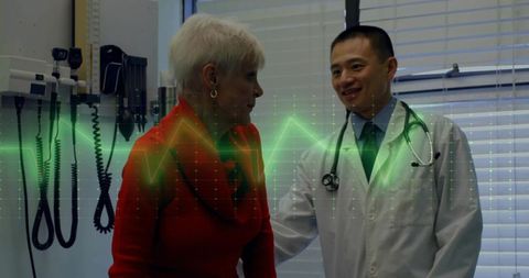 Doctor consulting elderly patient with ecg overlay in health clinic