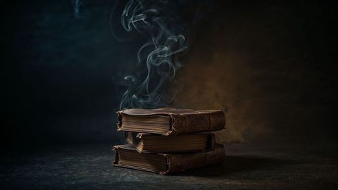 Mystical antique books with smoky wisps, evoking enigmatic aura