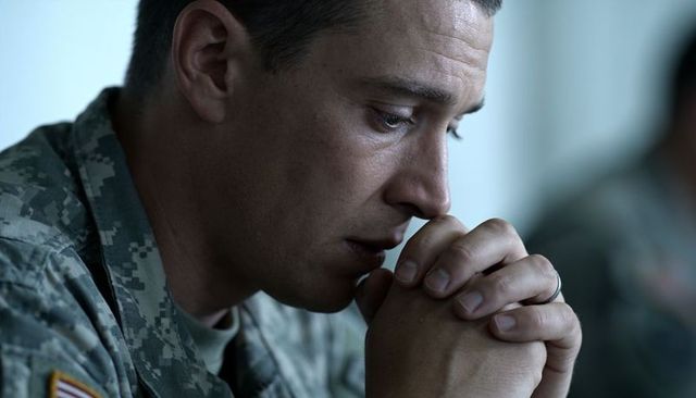 Contemplative us soldier wearing digital camo uniform and wedding ring during quiet briefing