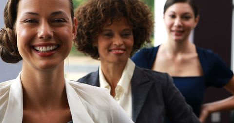 Diverse Female Executives Smiling Confidently in Office