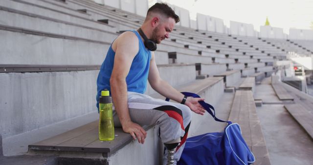 Man Preparing for Workout on Stadium Bleachers - Download Free Stock Images Pikwizard.com